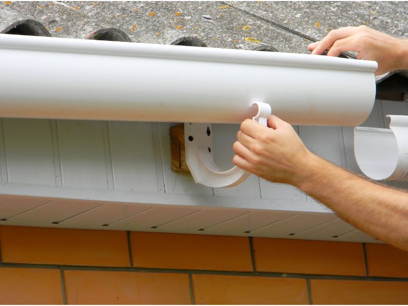 replacing a gutter on a roof